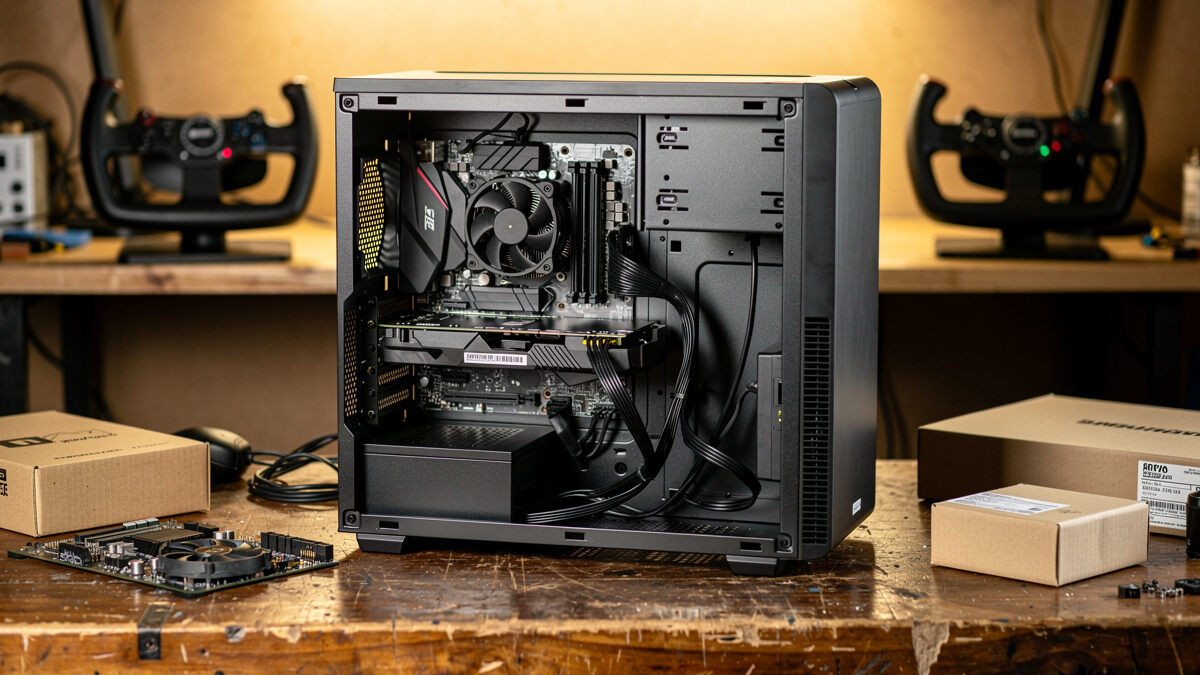 Budget flight sim PC build in progress on a workbench with parts boxes and a yoke