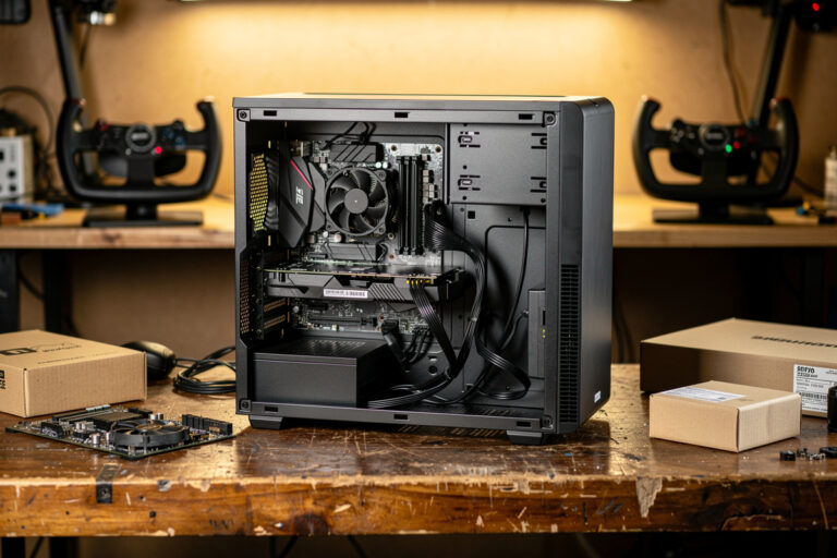 Budget flight sim PC build in progress on a workbench with parts boxes and a yoke
