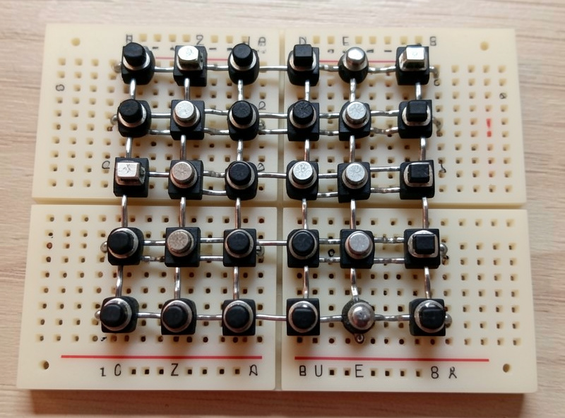 Breadboard layout of a button box switch matrix showing rows and columns of toggle switches