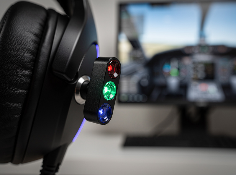 Infrared head-tracking clip mounted on a headset beside a flight sim monitor
