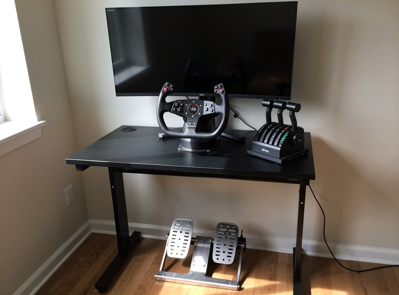 A mid-range flight sim setup with a yoke, throttle quadrant, and rudder pedals arranged together